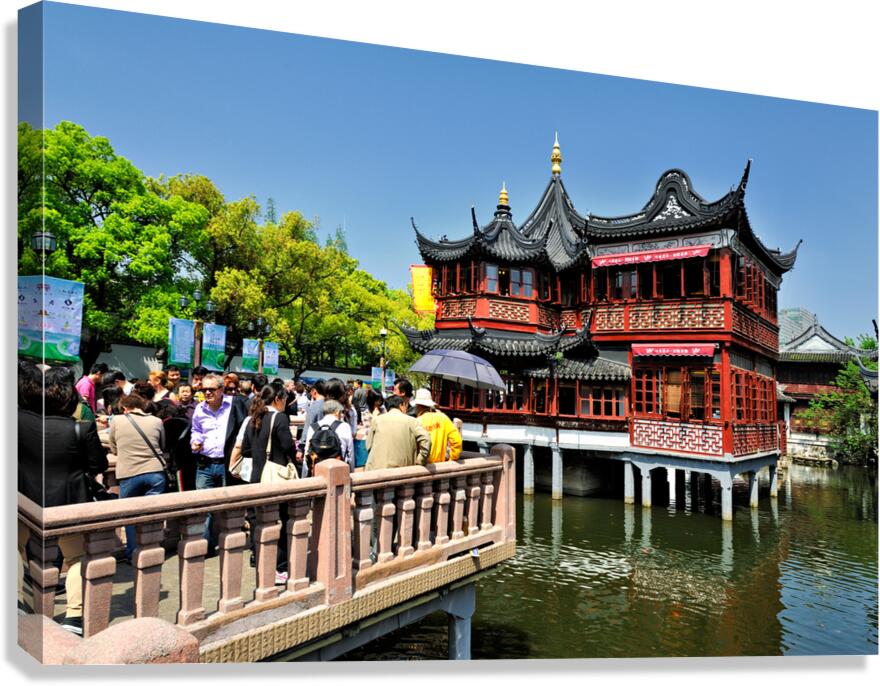 Crowd visits traditional Chinese tea house beside water in Shang