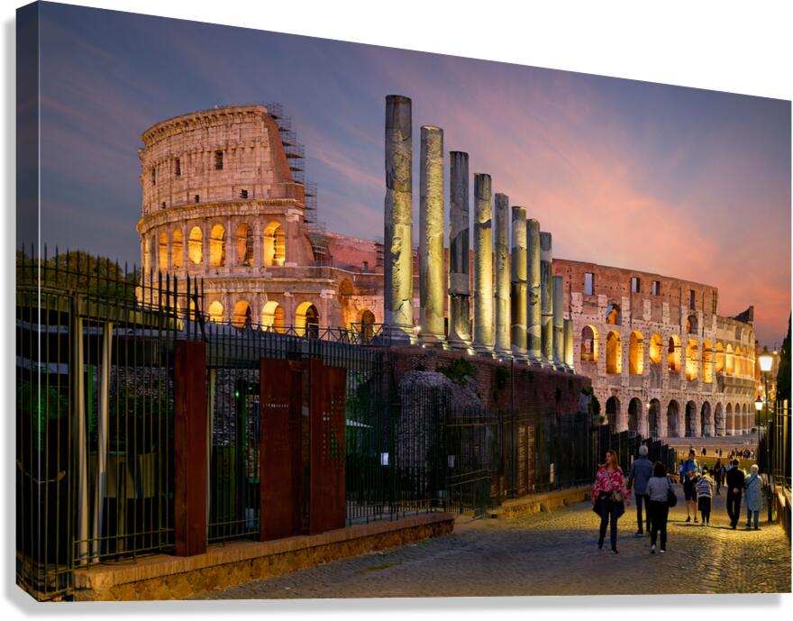 Visitors walking near the Colosseum in Rome at dusk