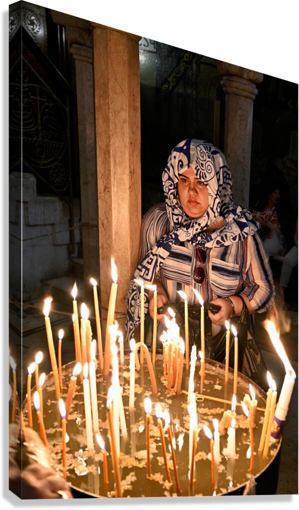 Worshipper lights candles at Holy Sepulchre church in Jerusalem