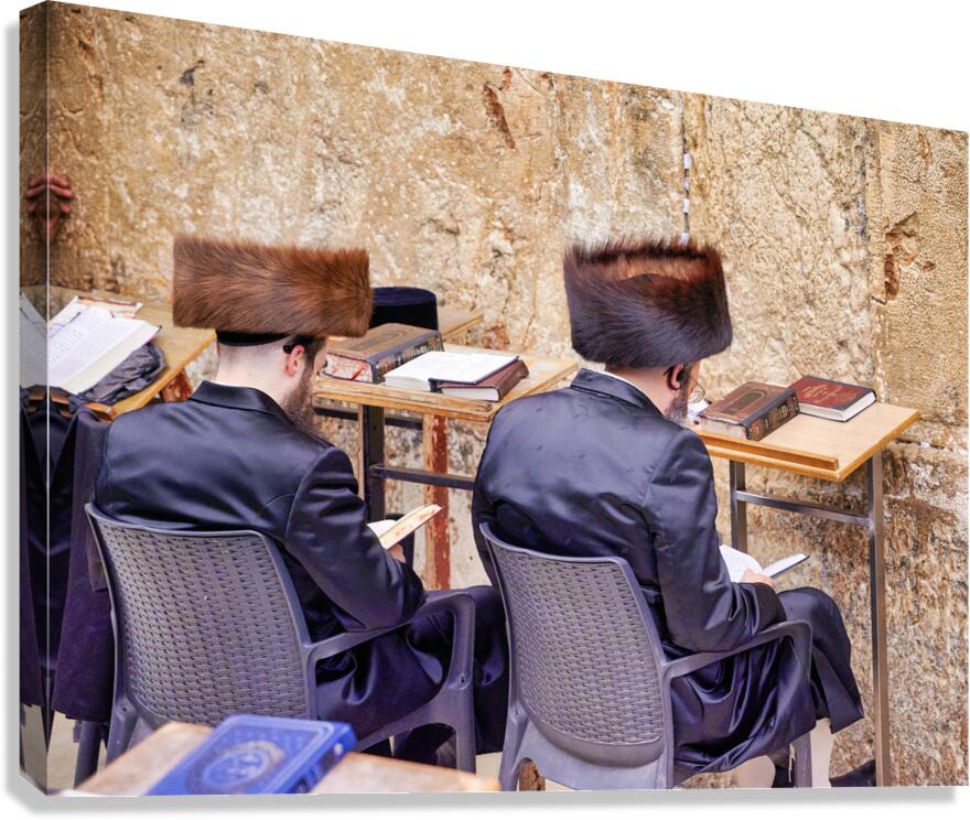 Orthodox Jews sit at tables by the Western Wall in Jerusalem