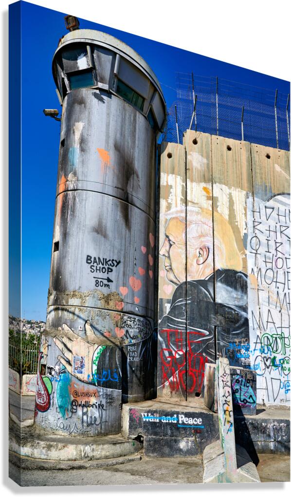 West Bank separation wall in Bethlehem shows street art and towe