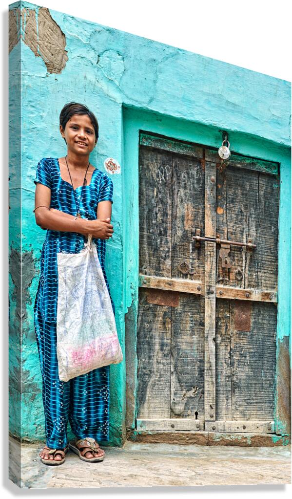 Girl standing in front of a door at her home in Mandawa India