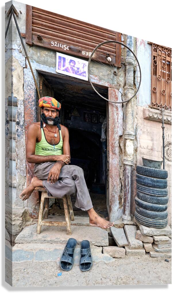 Man sitting outside a shop in Bikaner Rajasthan during the day