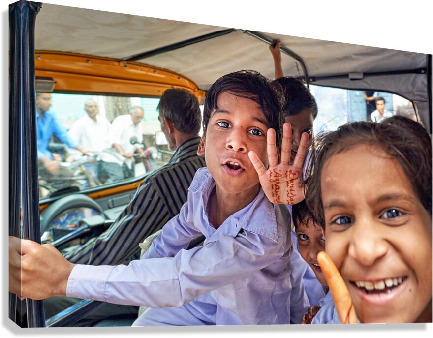 Smiling kids riding in a car in Bundi Rajasthan India