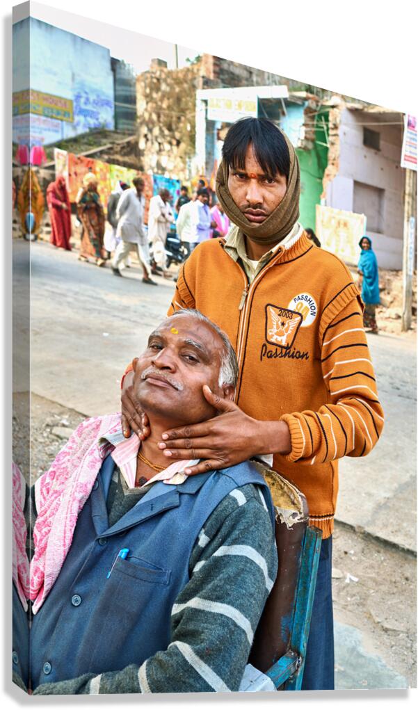 Barber serves customer on street in Orchha Madhya Pradesh Indi
