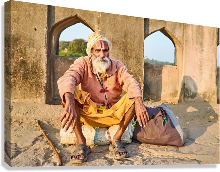 Holy man sitting outside historic building in Orchha India
