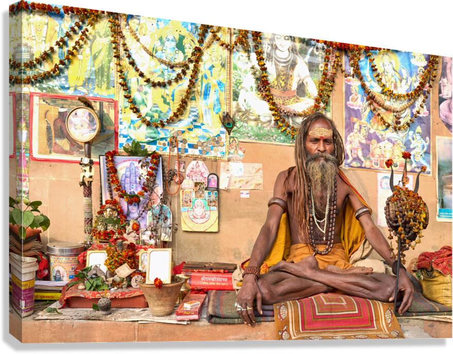 Sadhu sitting in Varanasi with offerings and religious symbols