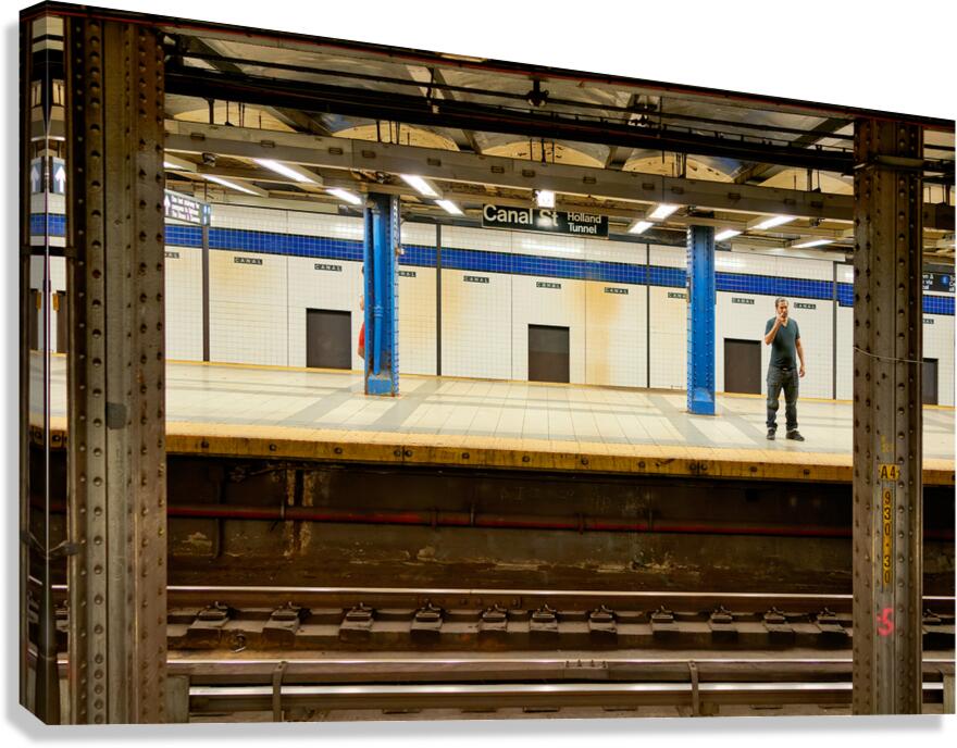 Man waits at Canal Street subway station in Manhattan