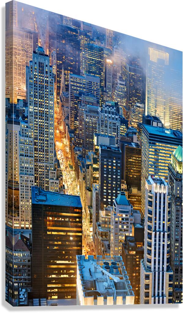 View of Manhattan streets at dusk with city lights shining brigh