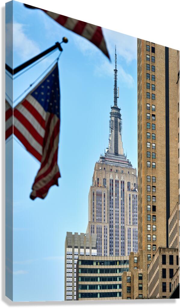 Empire State Building seen with flags in Manhattan New York Cit
