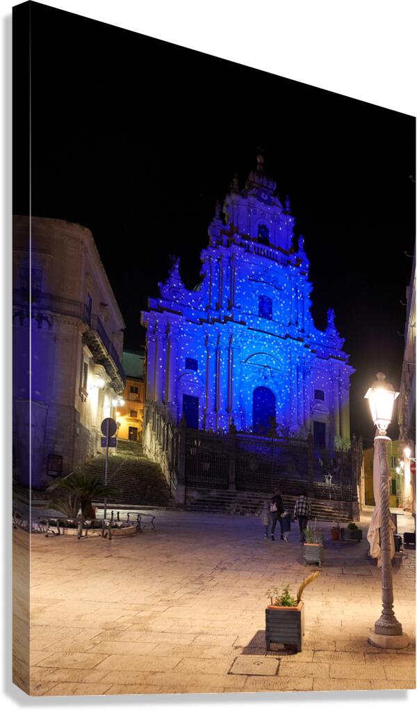 Visitors see Duomo of San Giorgio lit at night in Modica