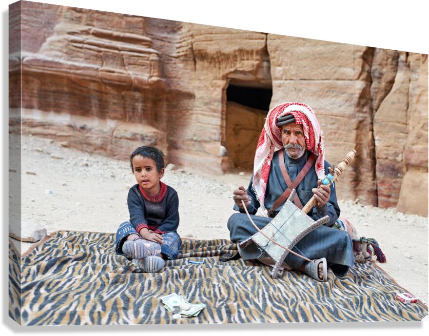 Musician performs in Petra Jordan with a child nearby