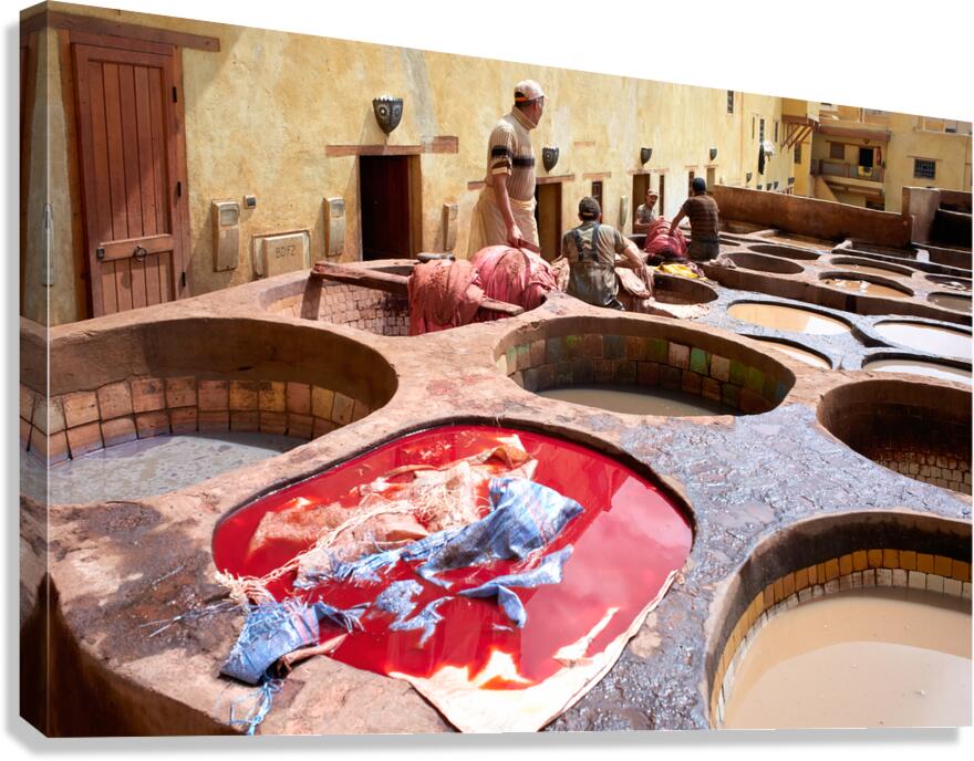 Workers dyeing leather at Chouara Tannery in Fez Morocco