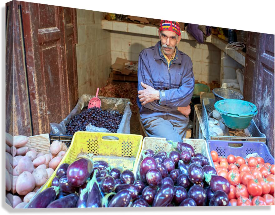 Greengrocer selling vegetables in Fez Morocco during the day