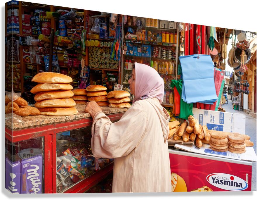 Woman buys bread in Fez Medina market