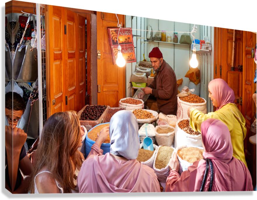Dried fruit market in Fez Medina with local customers and vendor