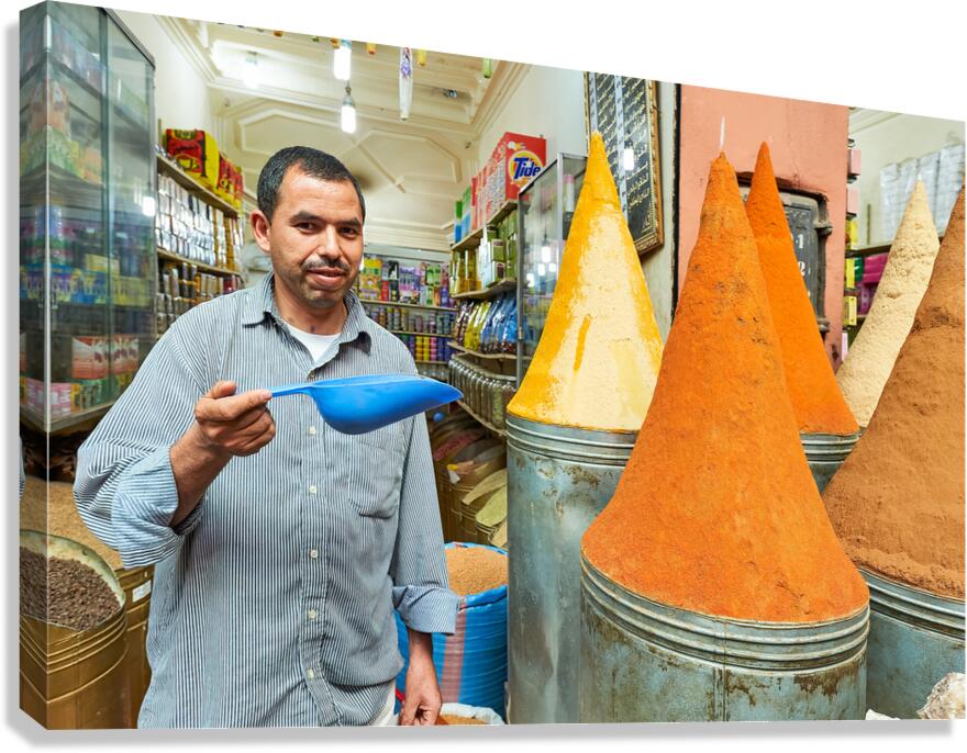 Sale of spices in Marrakesh souk with vendor showing products