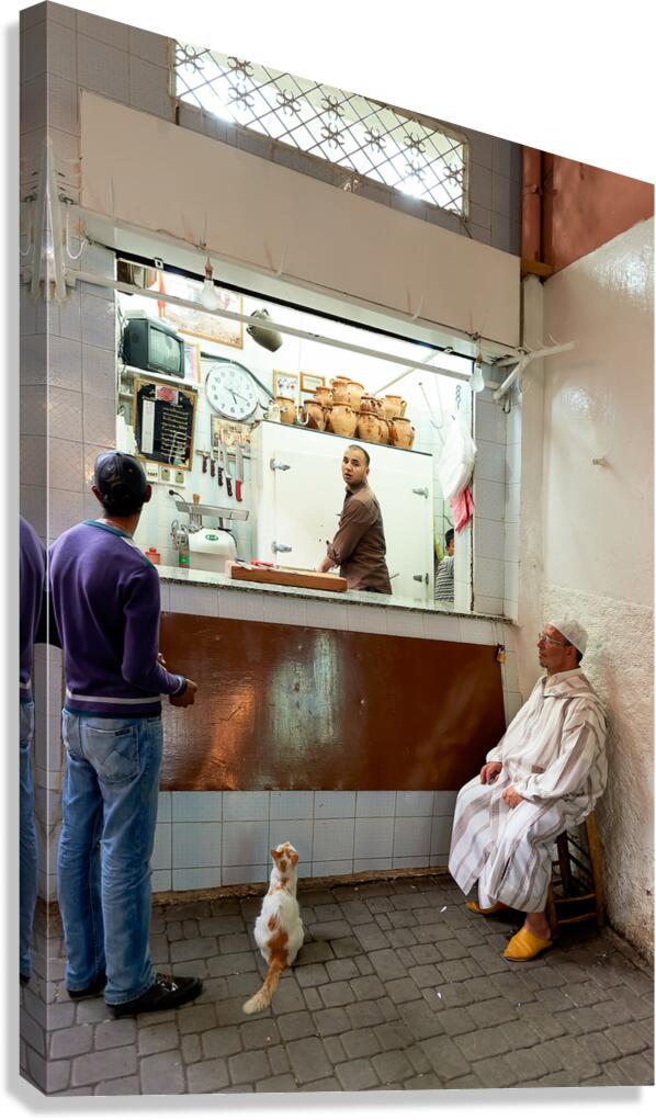 Busy shop in Marrakesh souk with local vendors and customers