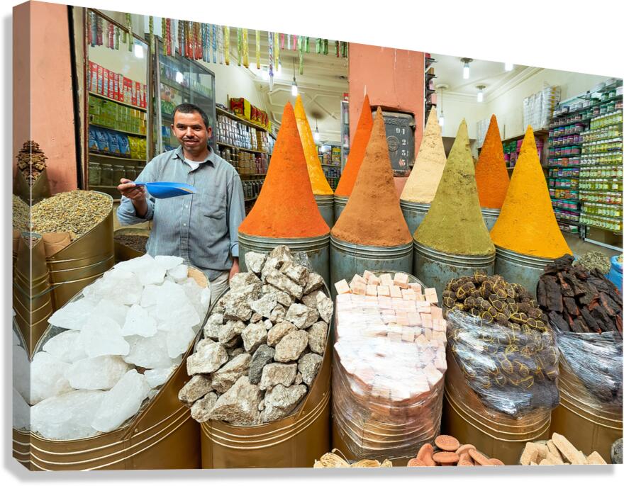Spice seller in souk of Marrakesh shows colorful spices in Moroc