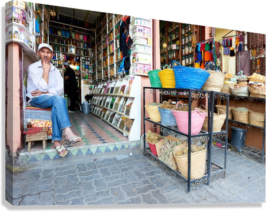 Shops in the Medina of Marrakesh with local vendor and baskets