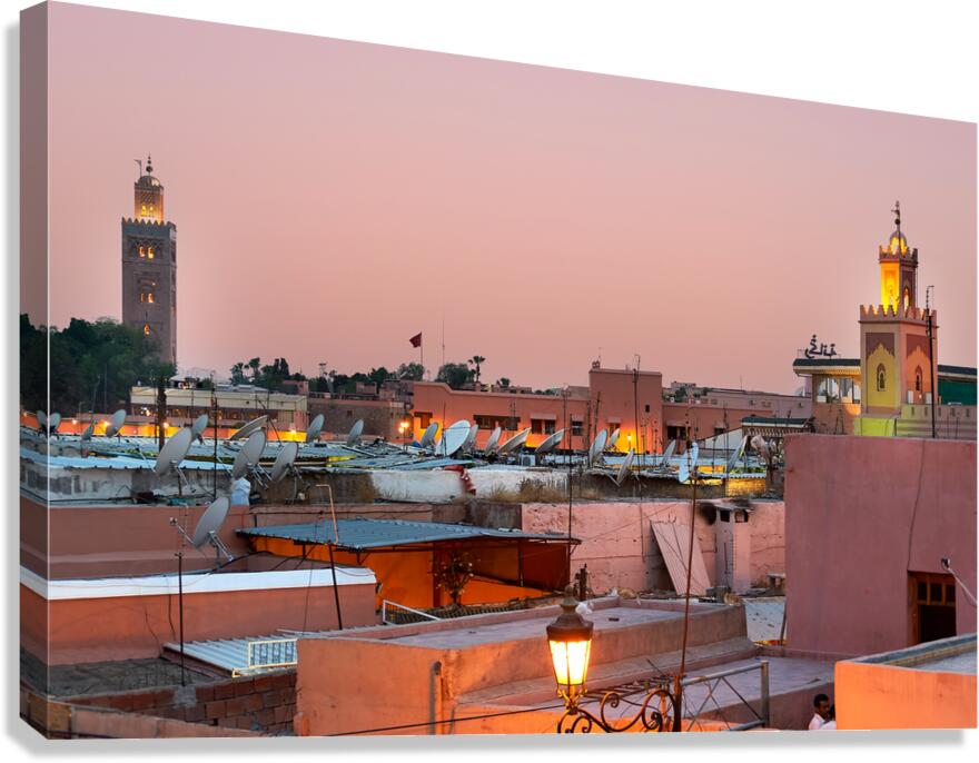 Cityscape of Marrakesh at sunset with buildings and minarets vis