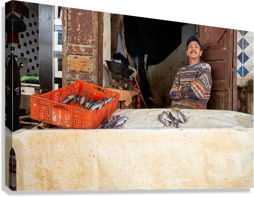 Fishmonger sits by his stall in Meknes Morocco market