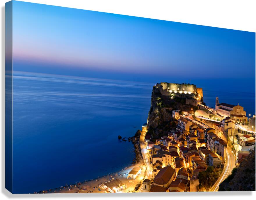 Illuminated Ruffo castle in Scilla Calabria at sunset over the s