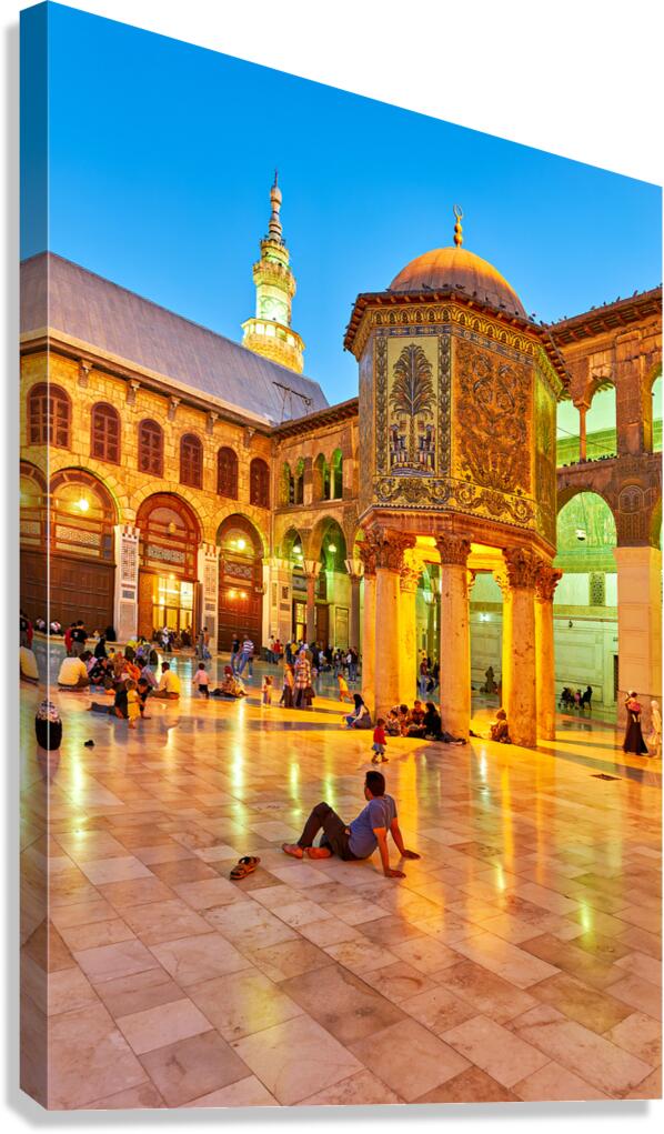 People gather in Umayyad Mosque courtyard during evening hours