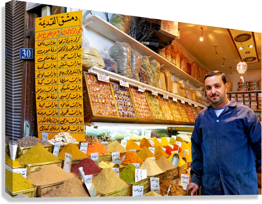 Spice vendor in Al Silah Souq selling colorful spices in Damascu