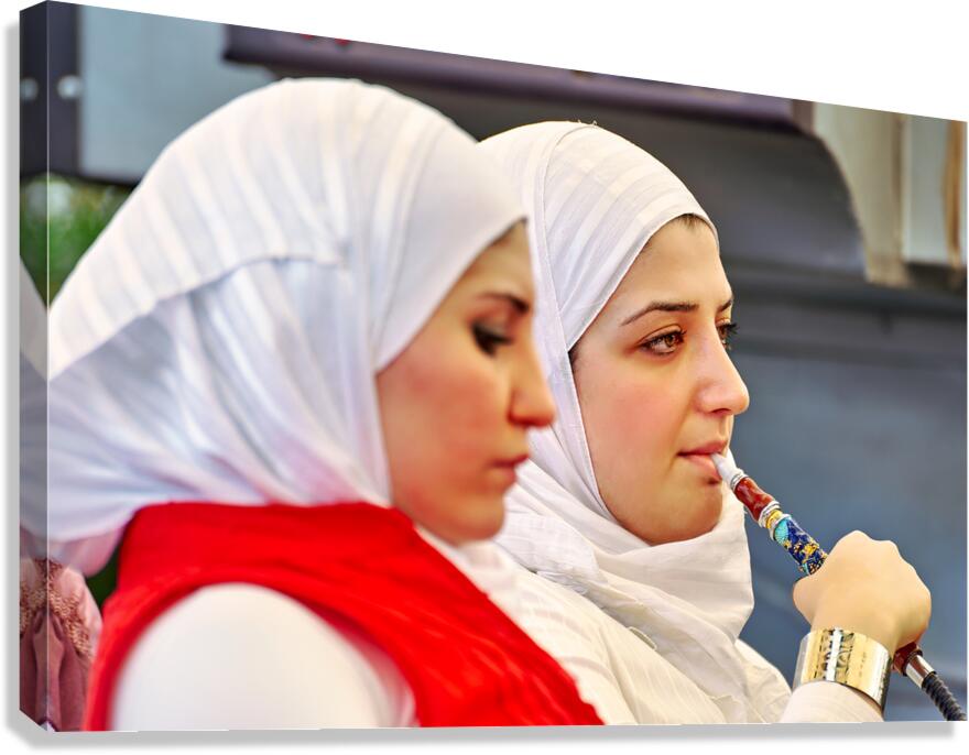 Young woman smokes hookah in Aleppo Syria