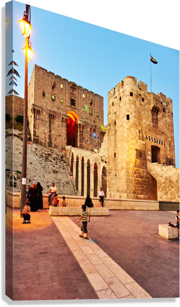 Citadel of Aleppo in Syria with people walking and playing