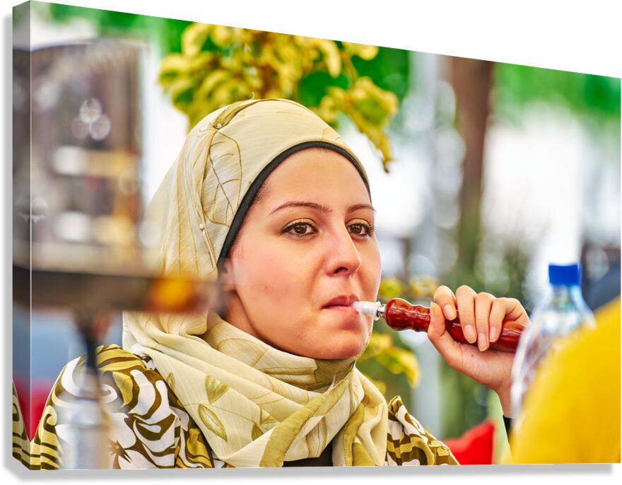 Young woman smokes hookah in Aleppo Syria during a sunny day