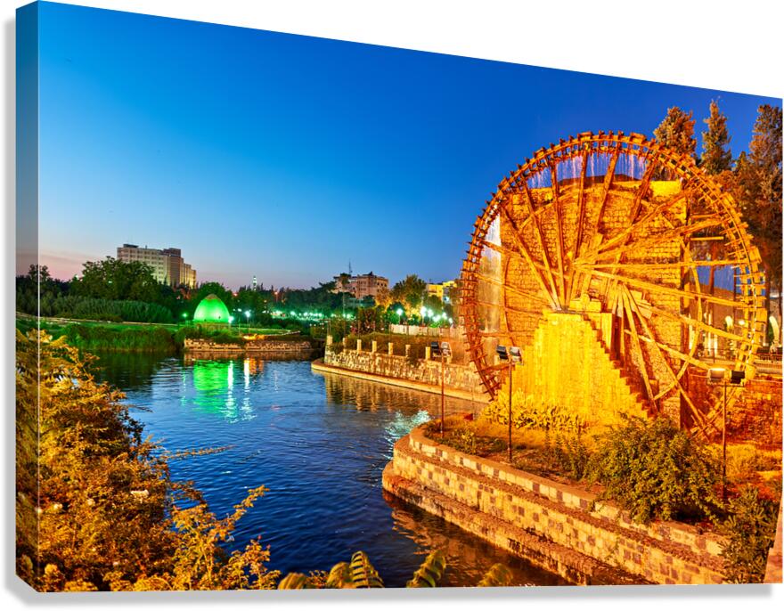 Water wheels in Hama Syria by the Orontes River at dusk