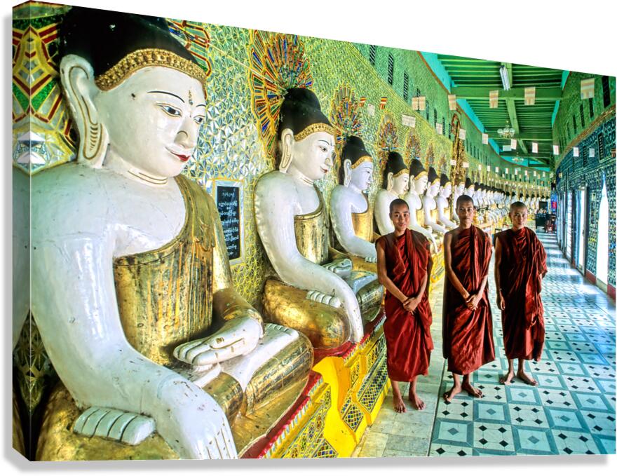 Monks stand by statues in Sagaing Paya in Myanmar