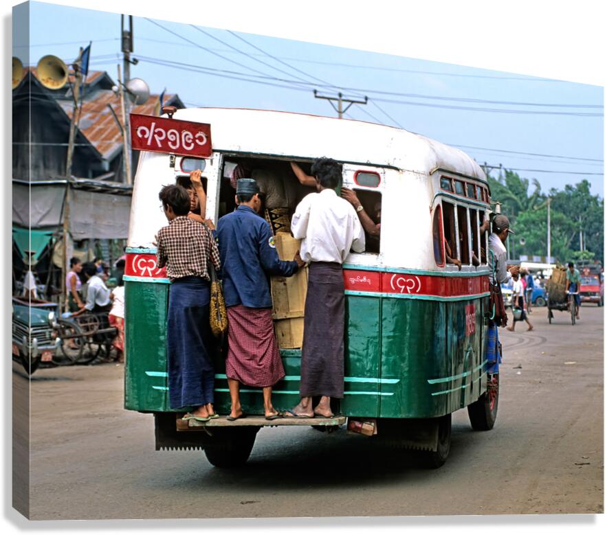 Busy bus transportation scene in Myanmar with people boarding