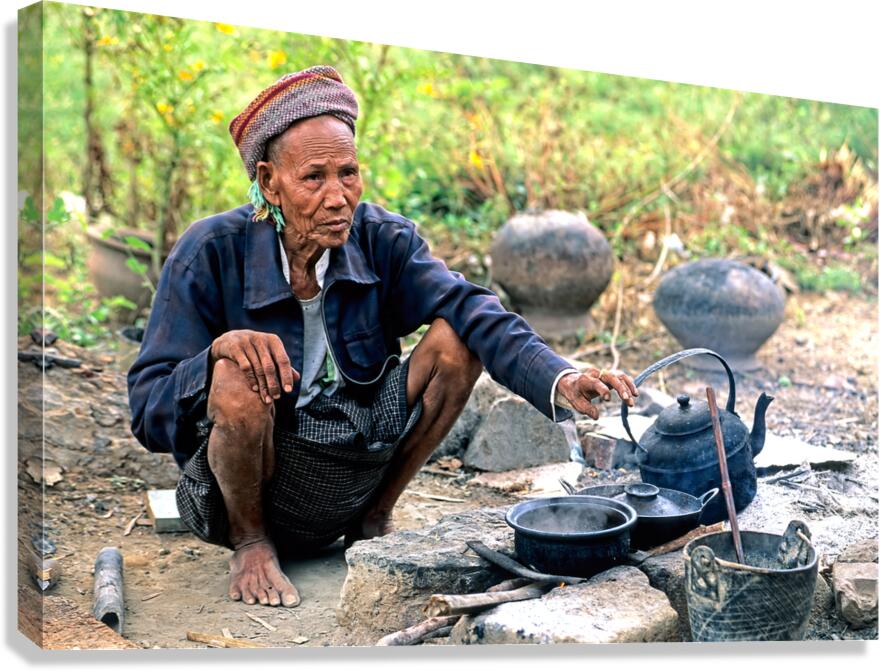Man prepares tea in Myanmar under a clear sky