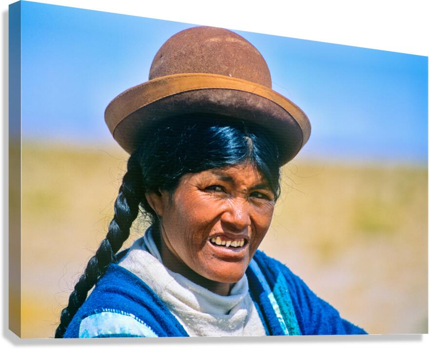 Smiling indigenous woman in hat and braid.