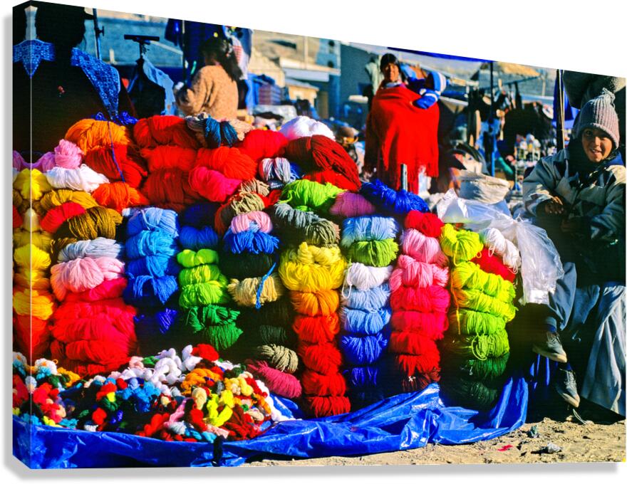 Vibrant market stall with colorful yarn and a smiling child.