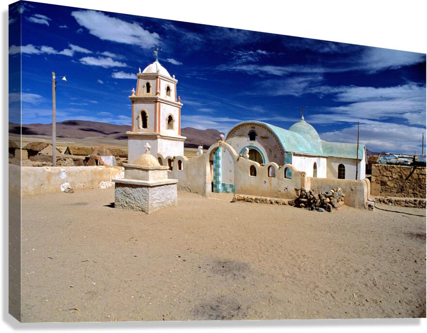 Remote desert church with bell tower under a dramatic sky.