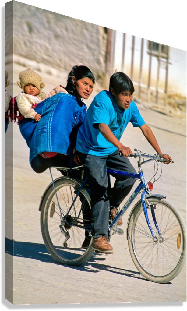 Family cycling with baby in sling.