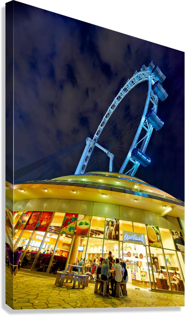 Visitors gather near Flyer in Singapore at night for city views