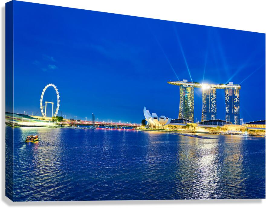 Sunset view of Marina Bay with city skyline and water reflection