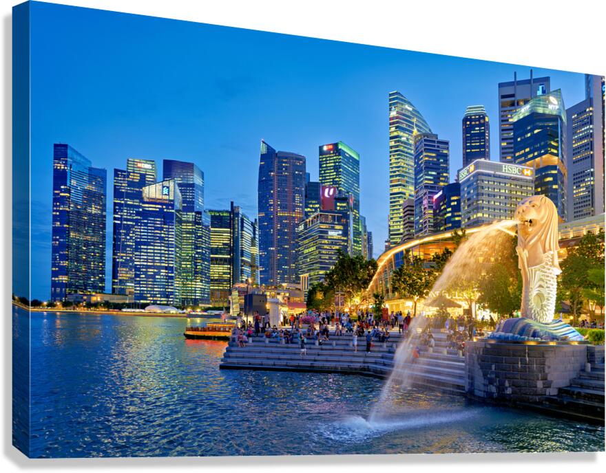 Visitors enjoy the Merlion fountain near Marina Bay Sands at dus