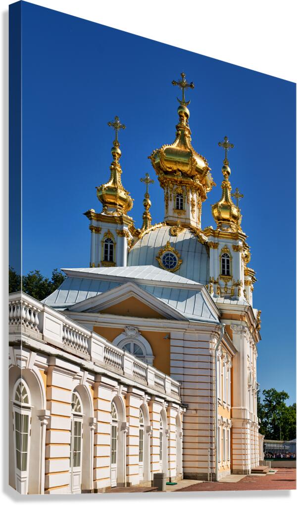 Golden domes of Peterhof Palace stand against blue sky