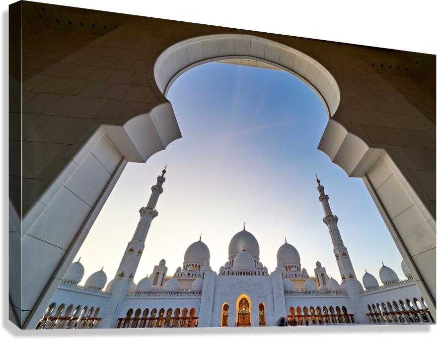 Sheikh Zayed Grand Mosque viewed from an arch at sunset