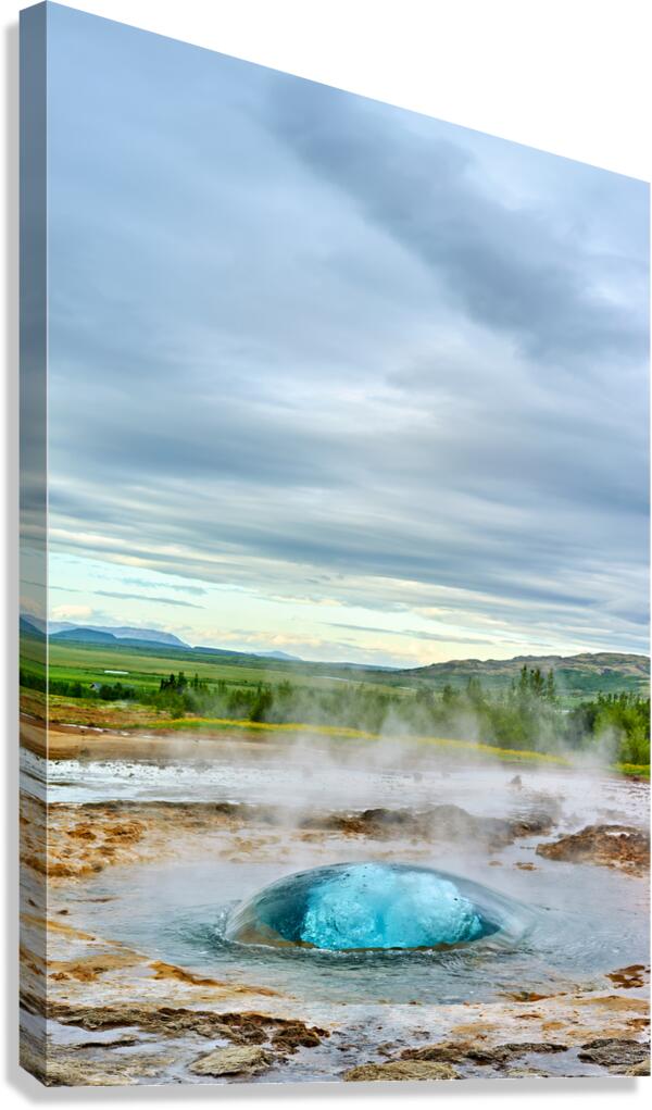Strokkur geyser erupts in Iceland during cloudy day