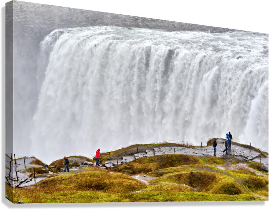 Visitors by Dettifoss waterfall in cloudy Iceland