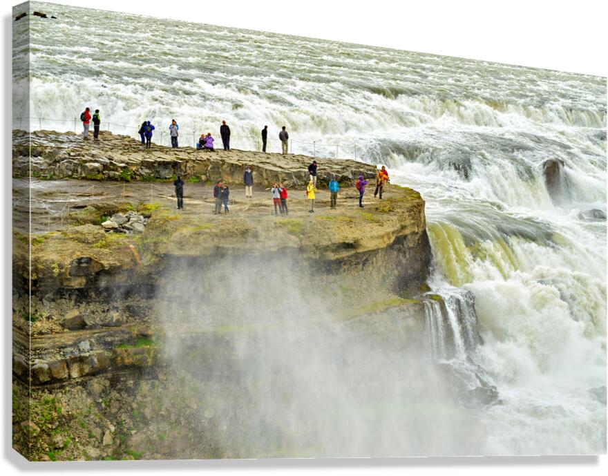 Visitors admire Gullfoss waterfall in Iceland on a cloudy day