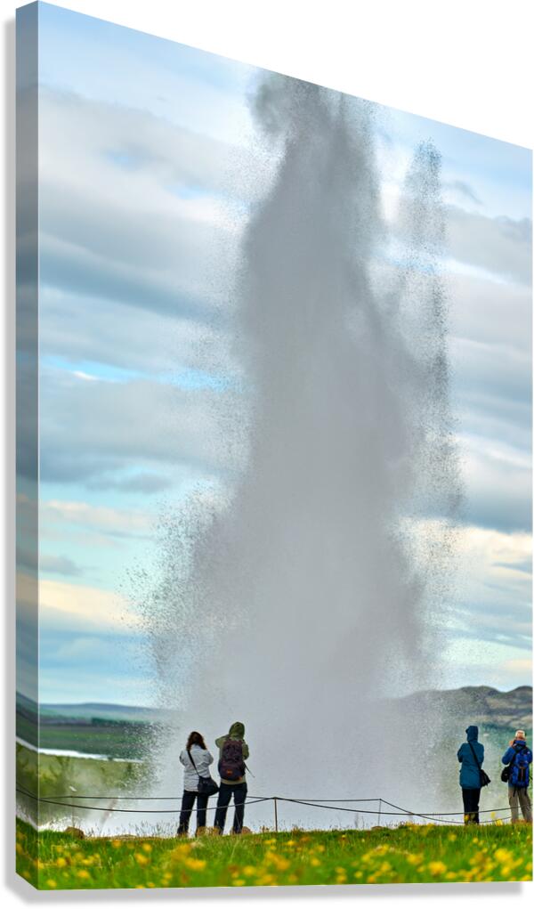 Strokkur geyser erupts in Iceland with visitors nearby