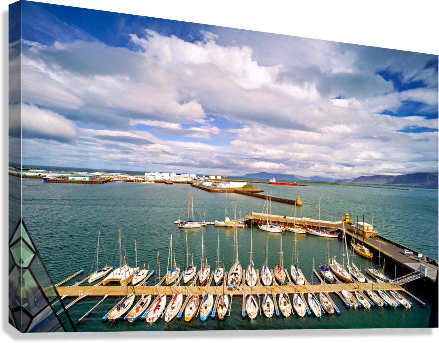 Harbor view in Reykjavik Iceland with sailing boats and clouds